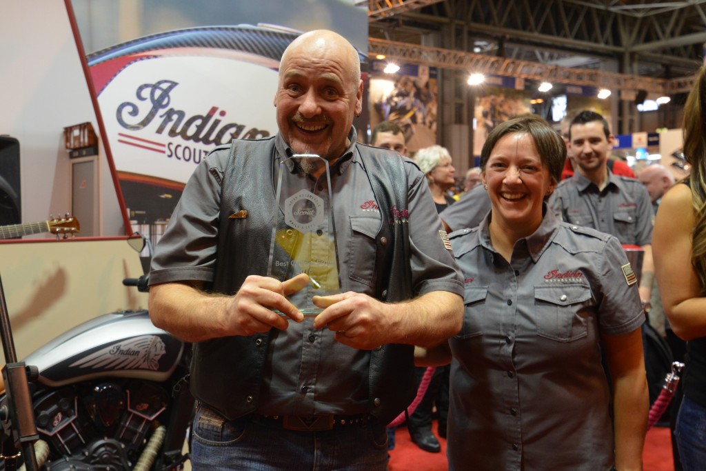Sarah Johnson, marketing specialist for Indian Motorcycle in the UK, presents Thor Motorcycles dealer principal Colin Treleaven with a trophy for winning Project Scout UK